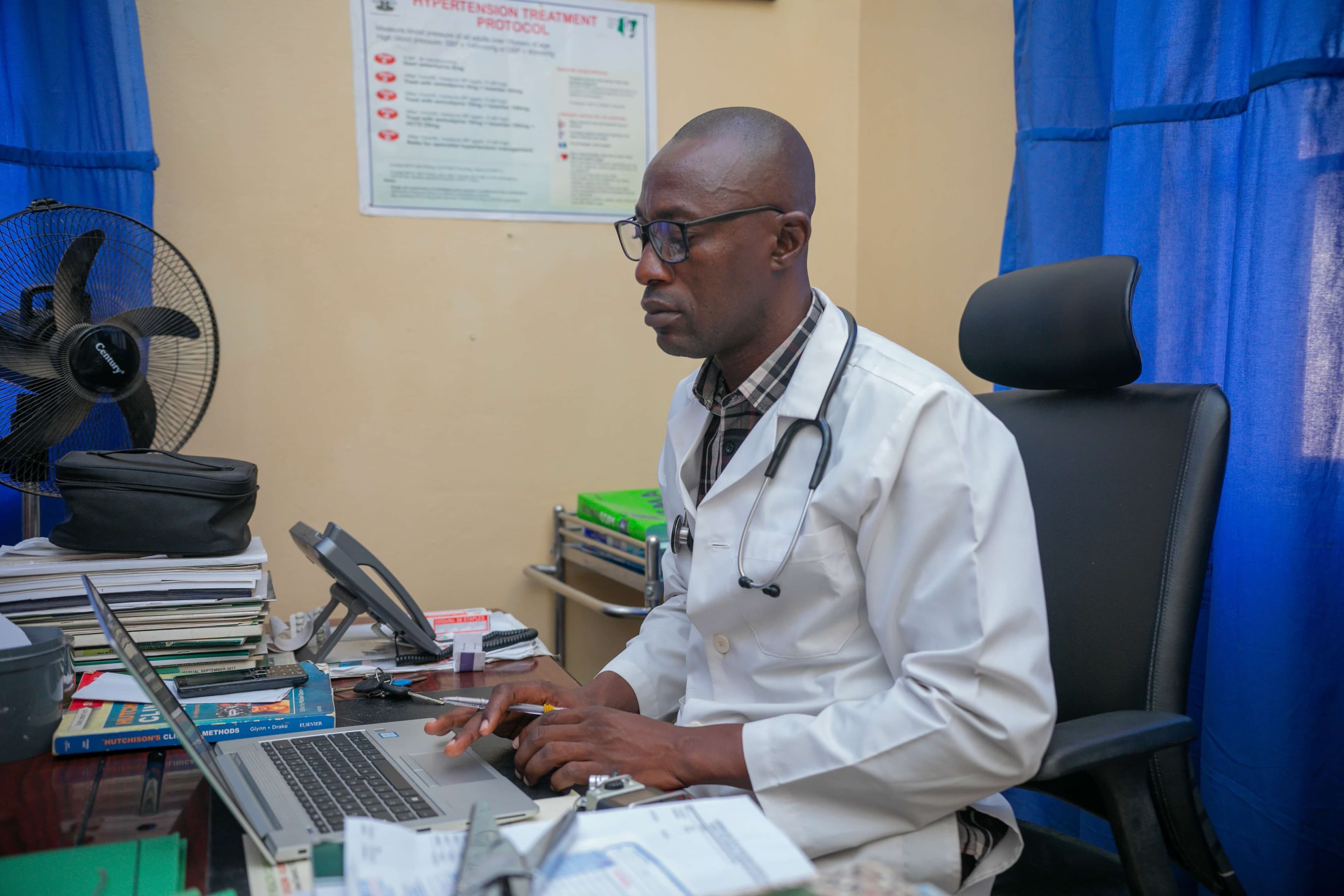 A health worker using the laptop for medical research